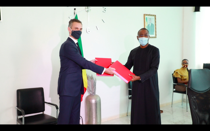 Echange de document entre le ministre sénégalais en charge de l'Economie (droite) et le directeur général de l'AFD (gauche) après la signature des prêts et subventions de financement liés au covid19.
