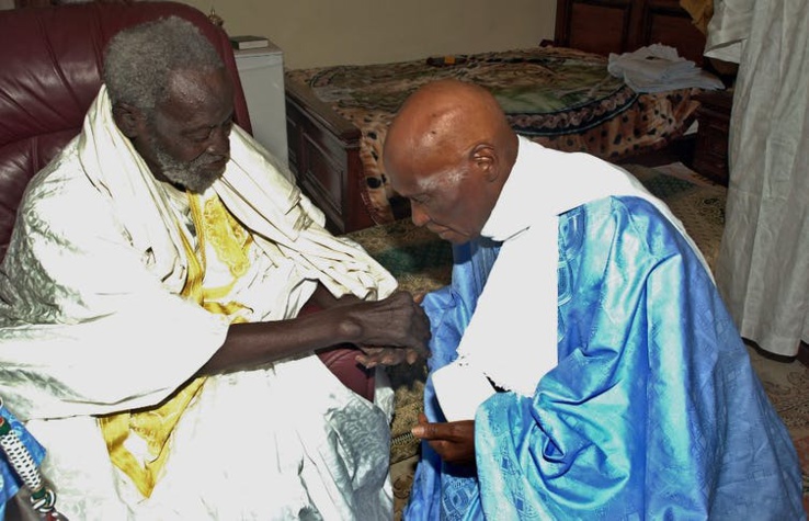 Me Abdoulaye s'agenouille devant son guide religieux.